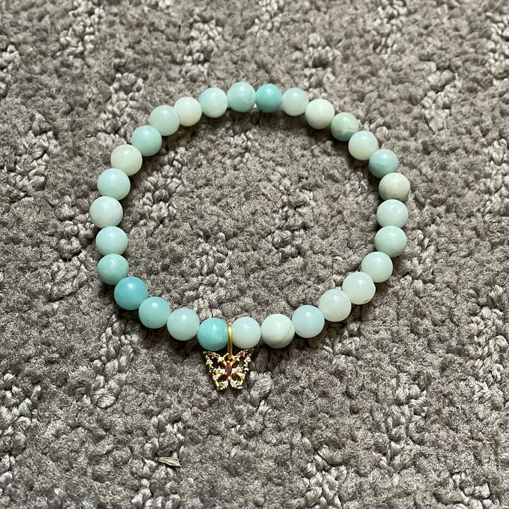 Turquoise bracelet with butterfly charm. Never worn. Great condition!